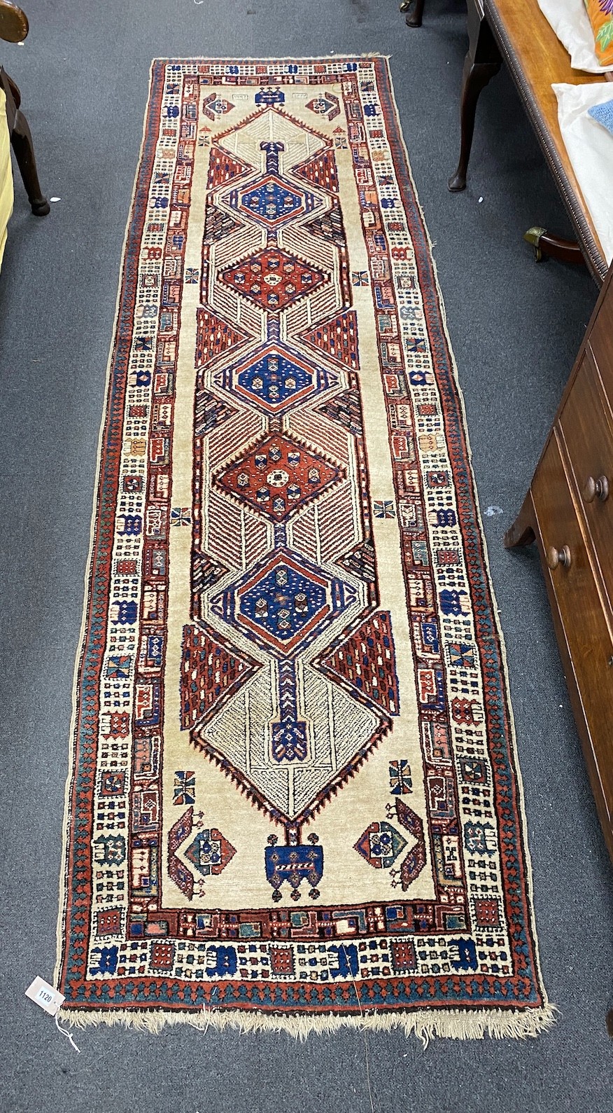 A Hamadan ivory ground runner with concentric medallion field, 320 x 96cm